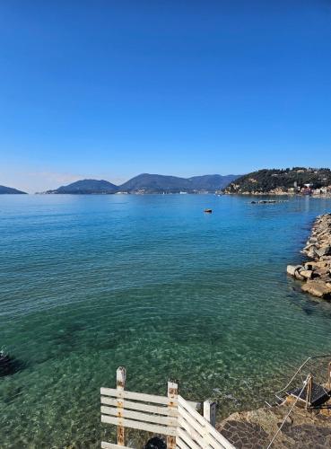 a view of a body of water with a white bench at IL PEPE ROSA di Anna e Silvano in Sarzana