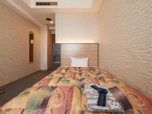 Postel nebo postele na pokoji v ubytování Gamagori Hotel