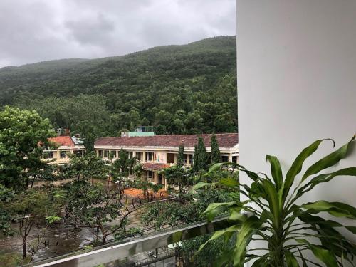 a view of a house with a mountain in the background at Sunny Homestay Quy Nhơn in Quy Nhon