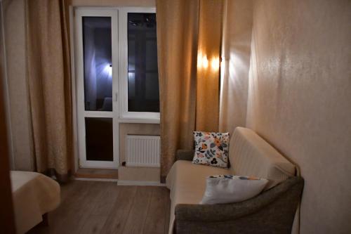a living room with a couch and a window at Comfortable 4-Room Apartments in Jekabpils in Jēkabpils