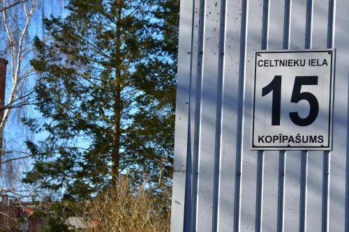 a sign on the side of a metal building at Comfortable 4-Room Apartments in Jekabpils in Jēkabpils