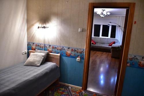 Comfortable 4-Room Apartments in Jekabpils في جيكاببيلس: غرفة نوم صغيرة مع مرآة وسرير