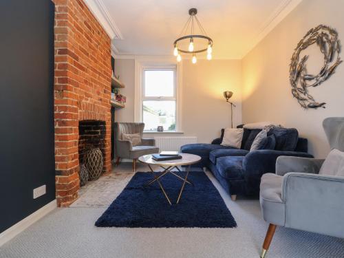a living room with a couch and a fireplace at First Light in Lowestoft