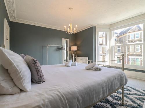 a large white bed in a room with a large window at First Light in Lowestoft