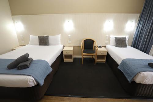 Ένα ή περισσότερα κρεβάτια σε δωμάτιο στο Sleepy Hill Motor Inn