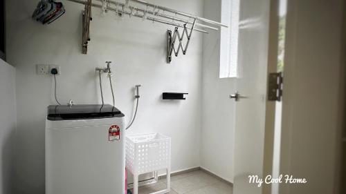 a laundry room with a washer and dryer on the wall at Sunway Onsen Suite Theme Park View Top Floor at Lost World in Tambun