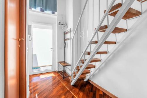 a staircase in a room with a wooden floor at -Ethnic Design Loft- con soppalco [Città Studi M2] in Milan