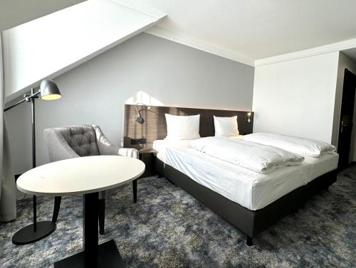 Postel nebo postele na pokoji v ubytování Lindgart Hotel Minden