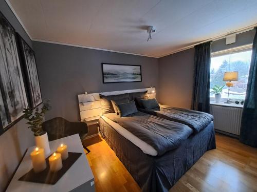 a bedroom with a bed and a table with candles at House in Trångsund, 15 min south of Stockholm, free parking, in Trångsund