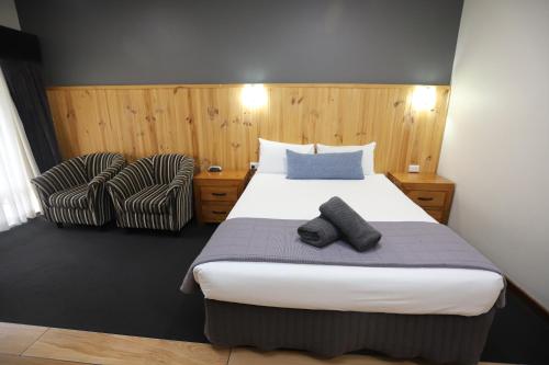 Ένα ή περισσότερα κρεβάτια σε δωμάτιο στο Sleepy Hill Motor Inn
