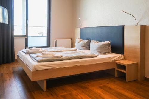 a bedroom with a large bed with a blue headboard at acama Hotel & Hostel Kreuzberg in Berlin