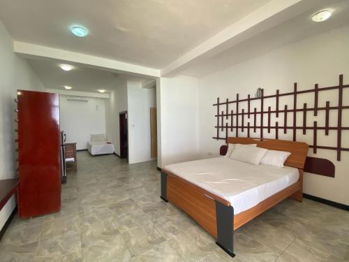 a bedroom with a large bed in a room at WASANA beach hotel in Induruwa