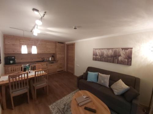 a living room with a couch and a table at Appartements Sportsüberl in Berwang