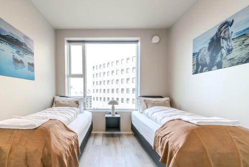Una cama o camas en una habitación de Sif Apartments by Heimaleiga