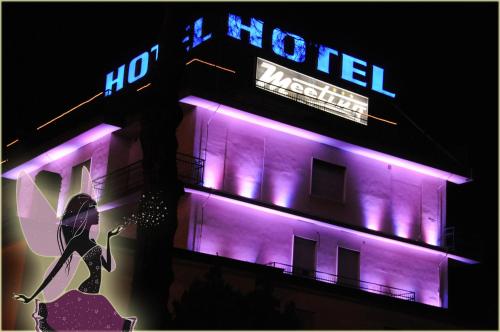 a hotel with purple lights on the side of it at Hotel Meeting in Ciampino