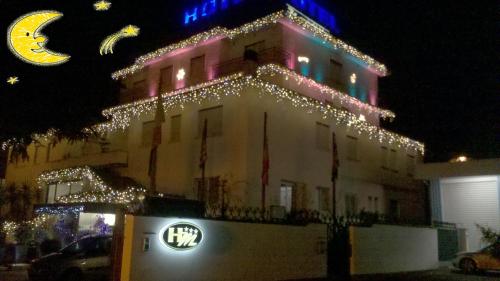 a lit up building with christmas lights on it at Hotel Meeting in Ciampino