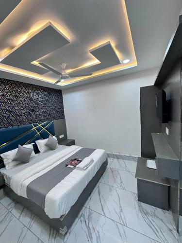 a bedroom with a bed and a television in it at Hotel The Pacific in Ahmedabad