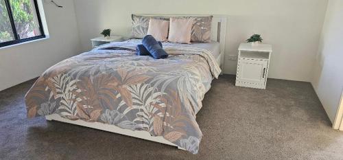 a bedroom with a bed with a comforter on it at Peaceful Escape in Perth