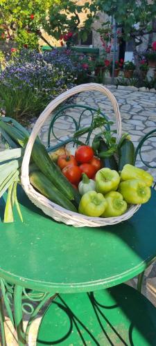 a basket of vegetables sitting on a green table at Senkini Dvori in Sutomišćica