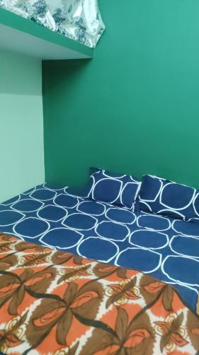 a blue bedroom with a bed with a flower pattern at Hari Suman Paying Guest house in Ayodhya