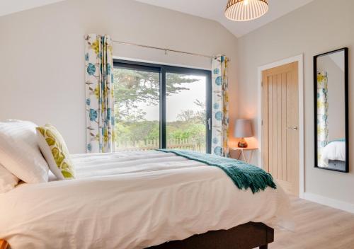 a bedroom with a large bed and a window at Polsue Gardens in Saint Clement