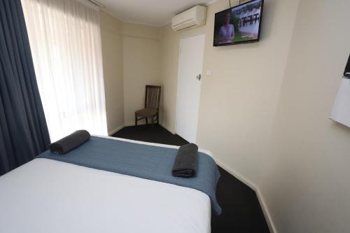 Ένα ή περισσότερα κρεβάτια σε δωμάτιο στο Sleepy Hill Motor Inn