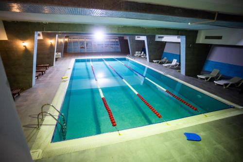 a large swimming pool in a building at CASPIAN BUSINESS HOTEL in Baku