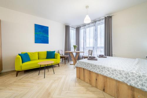 a bedroom with a yellow bed and a yellow couch at WOW studios for rent 2 bul Montevideo 25A - B in Sofia