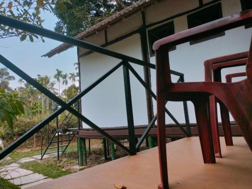 a red chair sitting in front of a building at Oryza wayanad in Kalpetta