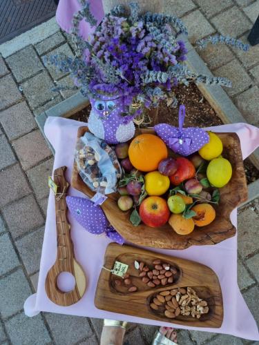 a table topped with plates of fruit and nuts at Senkini Dvori in Sutomišćica