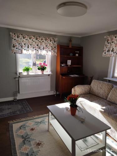 a living room with a couch and a coffee table at Molidens Gästgiveri Jönköping in Jönköping