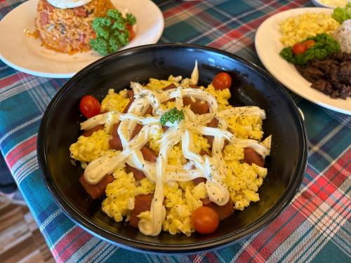 a black bowl of rice with mushrooms and other foods at Clark CU Hotel in Angeles