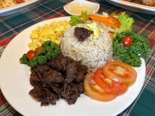 a plate of food with rice and meat and vegetables at Clark CU Hotel in Angeles