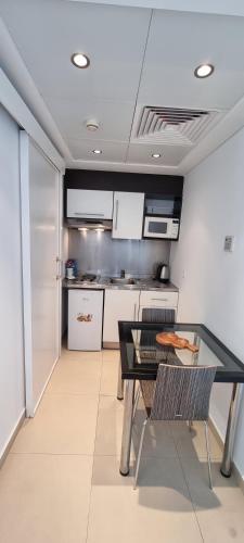a kitchen with a table and chairs in a room at Sky Suites in Beirut