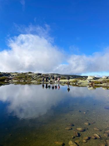 a group of people standing around a body of water at Casa dos Toros in Cortes do Meio