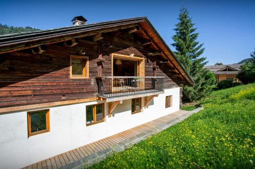 una casa con un balcón al costado en Chalet Backflip - OVO Network, en La Clusaz