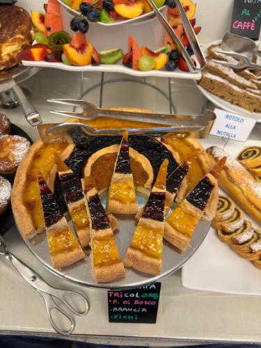 a tray of breads and pastries on a display at Hotel La Plage in Cattolica