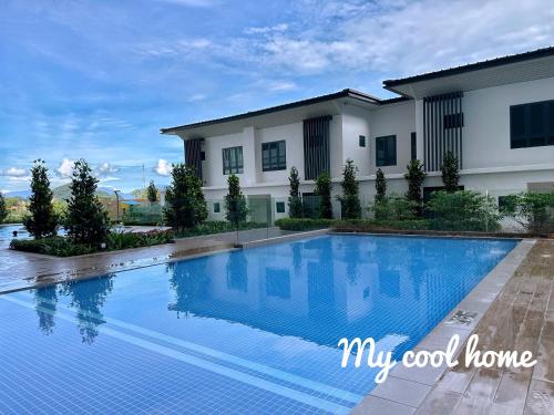 a swimming pool in front of a house at Sunway Onsen Suite Theme Park View Top Floor at Lost World in Tambun