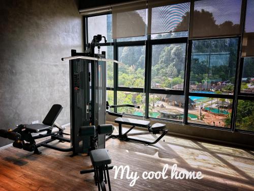 a gym with two tread machines and a large window at Sunway Onsen Suite Theme Park View Top Floor at Lost World in Tambun