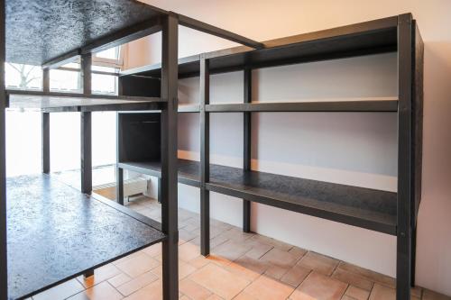 a bookcase in a room with black shelves at acama Hotel & Hostel Kreuzberg in Berlin