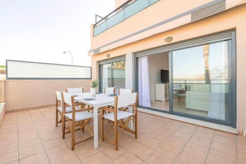 a dining room with a table and chairs on a balcony at Atardecer en Sanlúcar in Sanlúcar de Barrameda