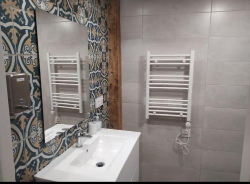 een badkamer met een wastafel en een spiegel bij Family in León