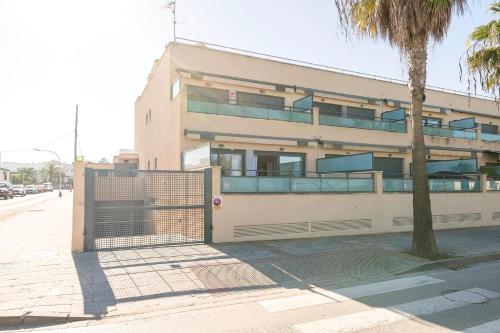 a building on the side of a street with a gate at Atardecer en Sanlúcar in Sanlúcar de Barrameda