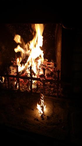 a fire in a fireplace with flames in it at Boeritza Hotel Complex in Vladaya