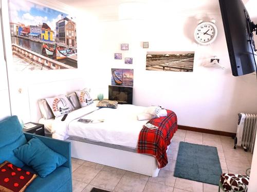 a bedroom with a bed and a clock on the wall at Aveiro Central Its ALL there Apartment in Aveiro