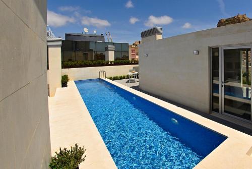 a swimming pool on the side of a building at Holihome Rambla 24 in Alicante