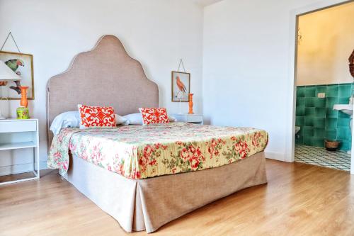 a bedroom with a large bed with red pillows at Villa Giulia in SantʼAgata sui Due Golfi