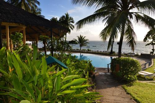 a resort with a swimming pool next to the ocean at Baobab Beach Resort & Spa in Diani Beach