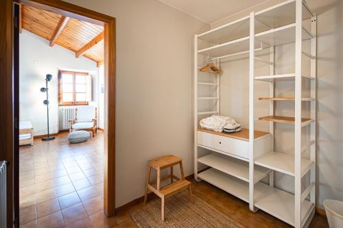 a room with a white book shelf and a table at Santuario De Bellmunt in Sant Pere de Torelló