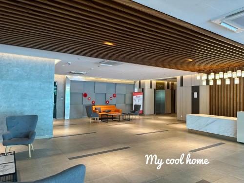 a lobby with a table and chairs in a building at Sunway Onsen Suite Theme Park View Top Floor at Lost World in Tambun